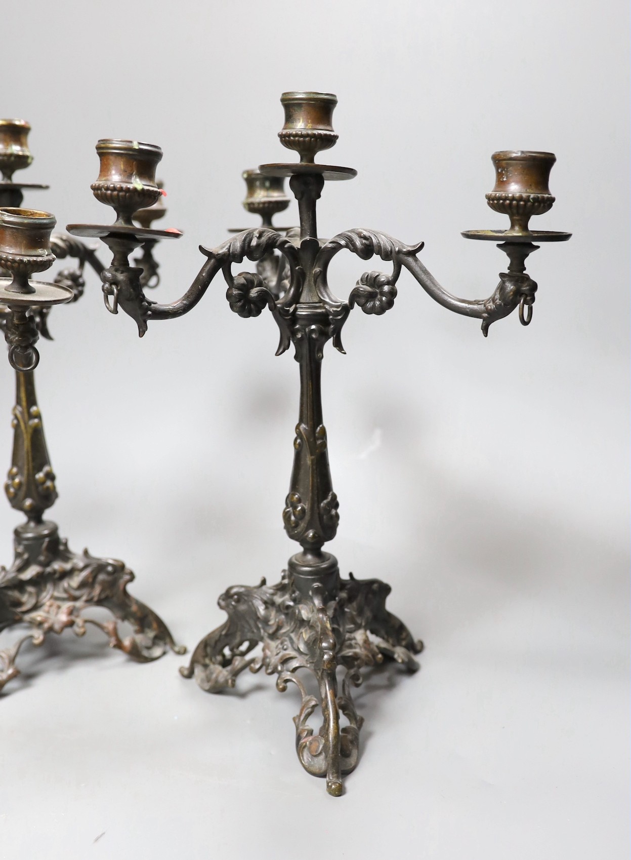 A pair of Victorian style bronze three branch candelabra, 32cm